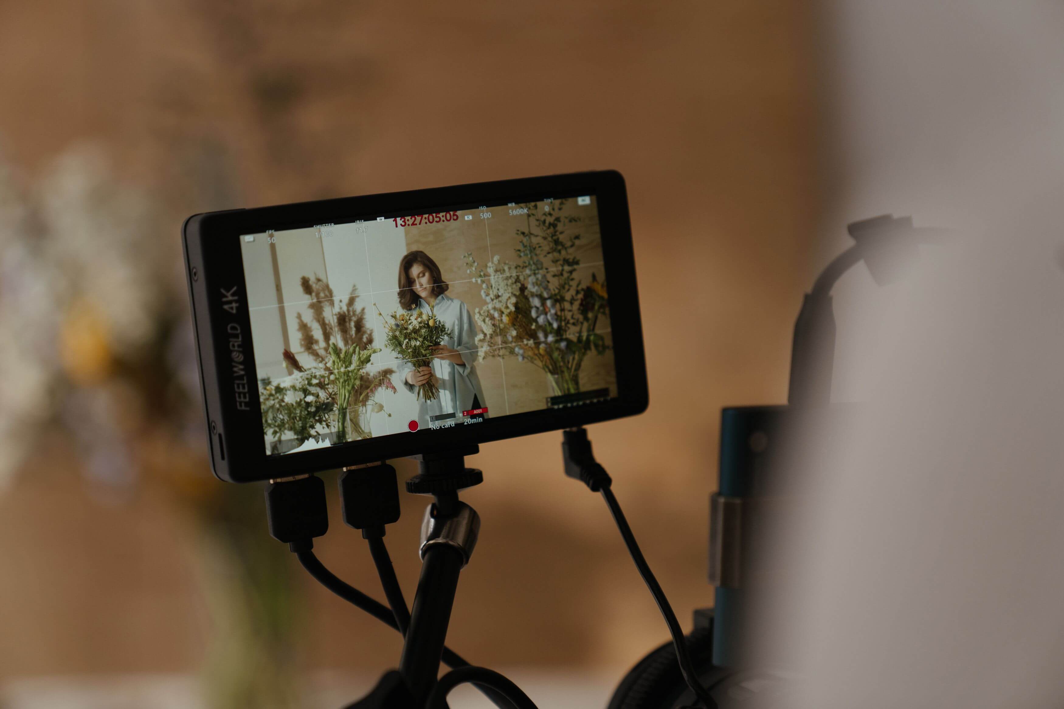 An on-camera monitor showing the live image from a shoot, with timecode and recording status over the frame.